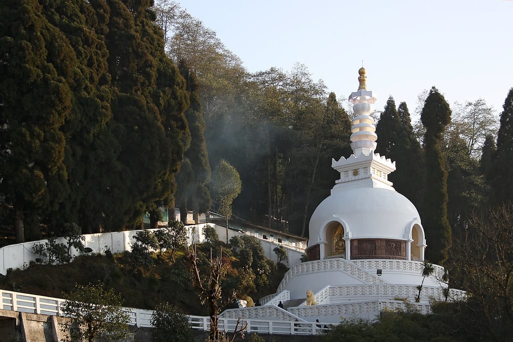 White Peace Pagoda surrounded by greenery on Jalapahar Hill in Darjeeling