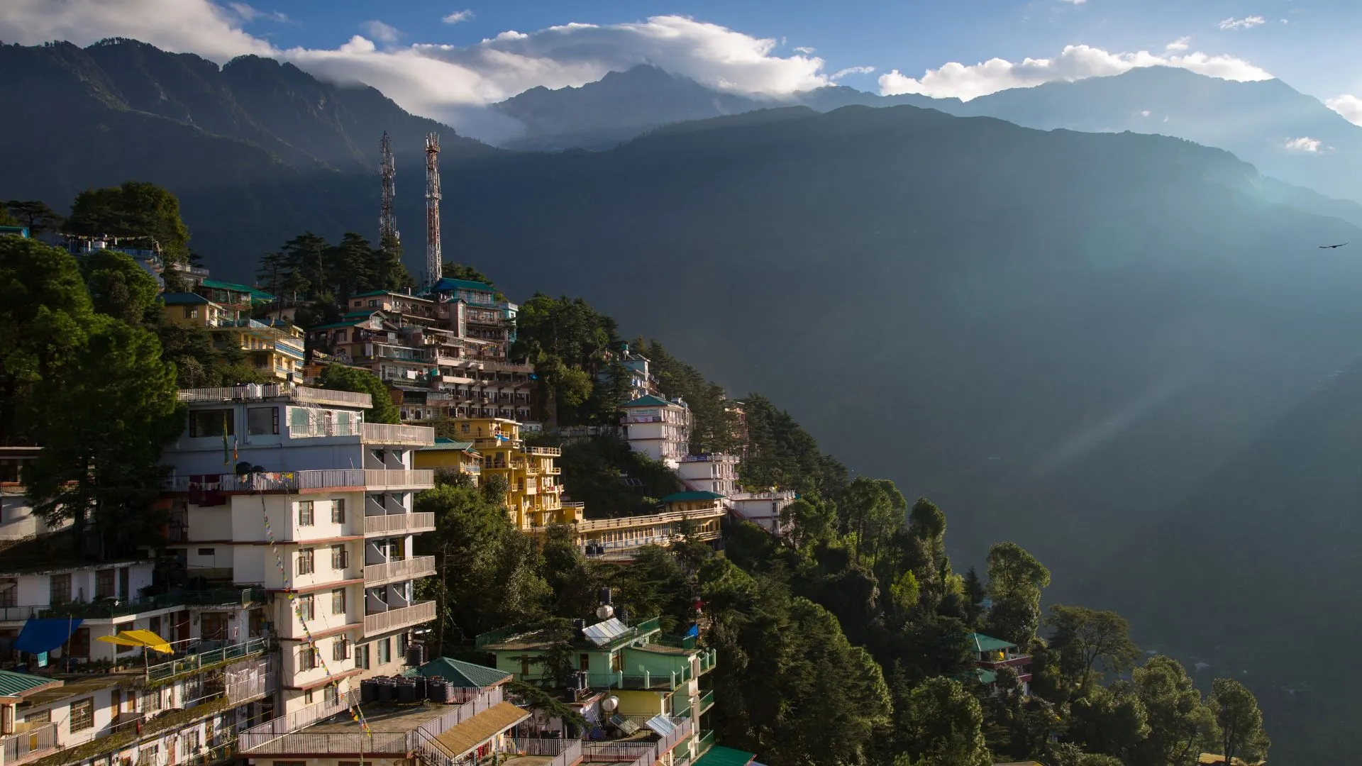 oy train passing through Batasia Loop and Gorkha War Memorial garden in Darjeeling